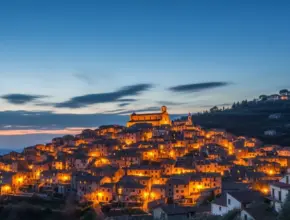 From soap bible study: matthew 5:14-16, a glowing city on a hill at dusk with warm lights shining across the landscape, symbolizing Jesus’ teaching in Matthew 5:14-16 about being the light of the world.