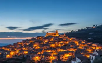 From soap bible study: matthew 5:14-16, a glowing city on a hill at dusk with warm lights shining across the landscape, symbolizing Jesus’ teaching in Matthew 5:14-16 about being the light of the world.