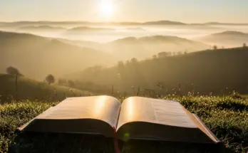 Peaceful sunrise with open Bible representing new life through the Holy Spirit from Romans 8:5-11.